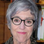 Headshot of Christine Gordon. She has short silver hair and dark glasses. 